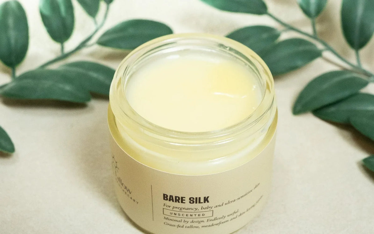 An open jar of Bare Silk tallow balm